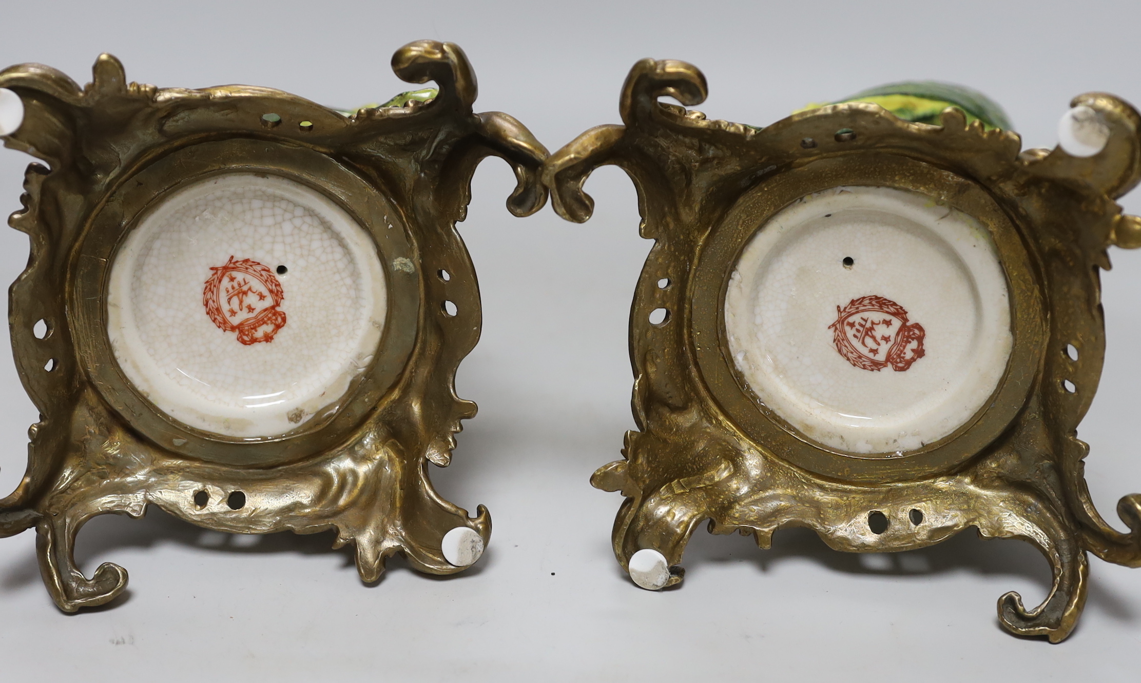 A pair of modern gilt metal mounted ceramic parrot candlesticks, 36cm